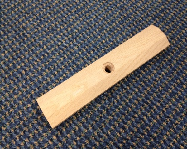 Custom wood mouldings and dimension stock made into a wooden brush block with a cross bore hole, available in bulk.